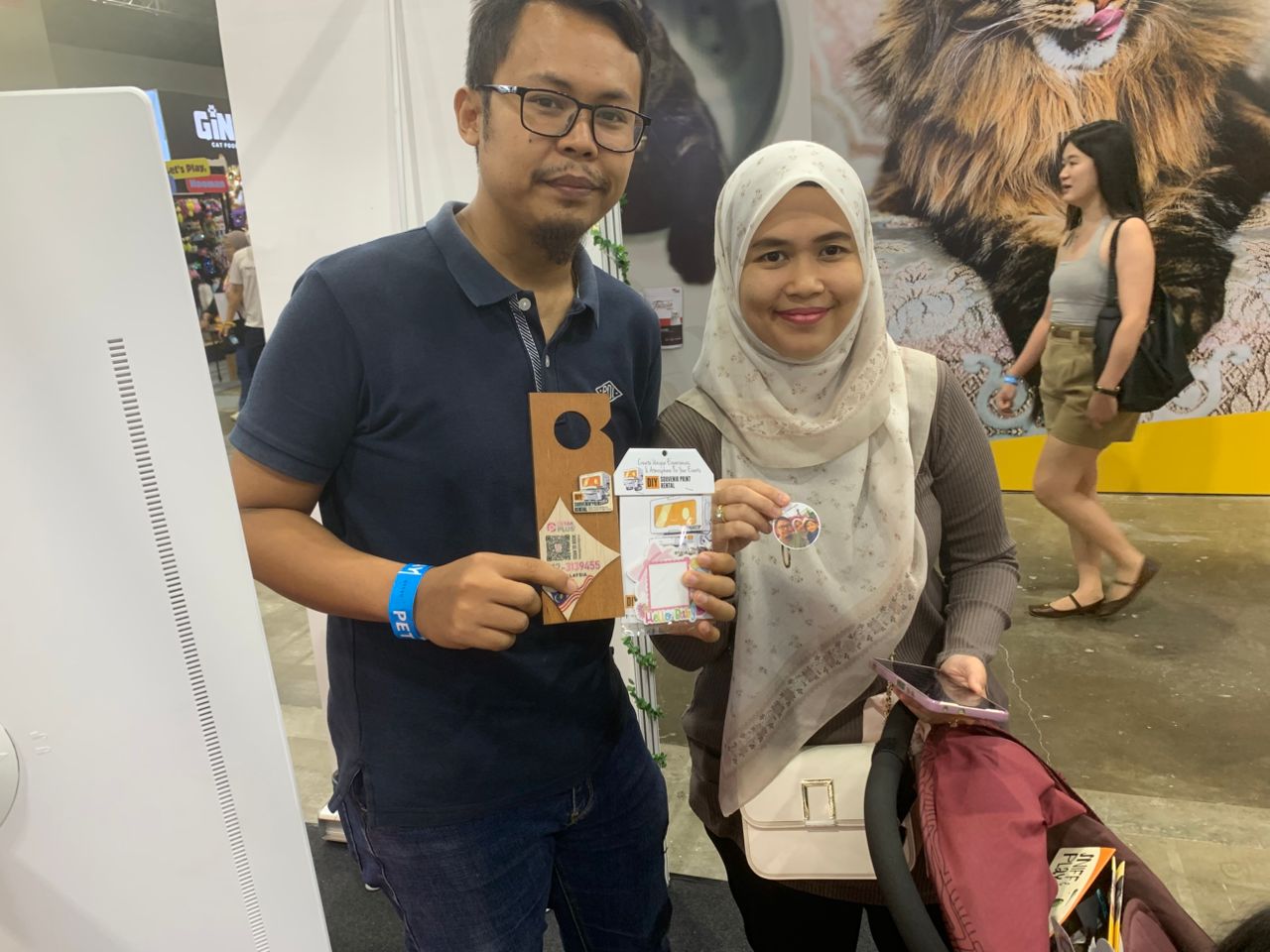 A couple showing off their custom printed souvenirs