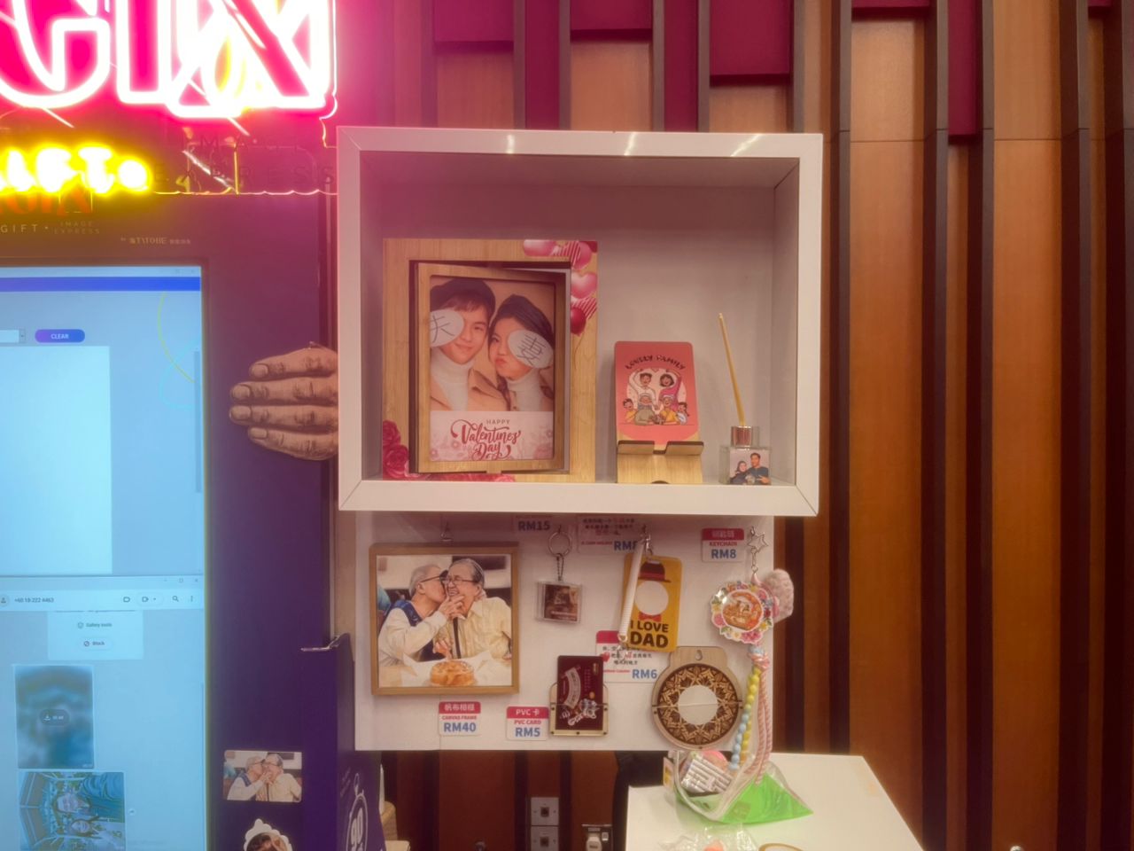 Magix merchandise display of framed photos, keychains and cards